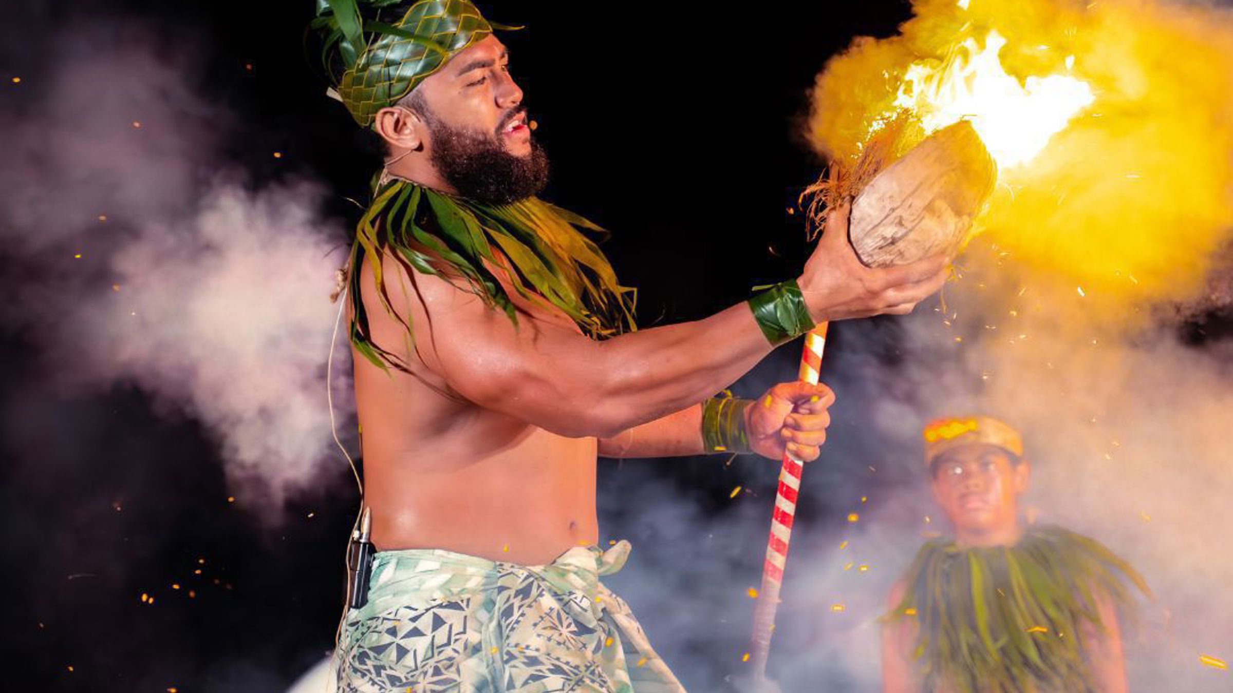 A fire knife dancer performing at night