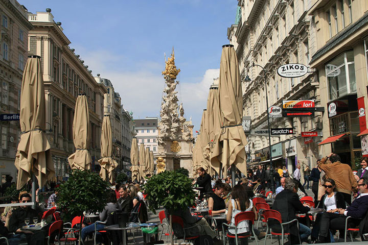Busy pedestrian street lined with cafes in central Vienna