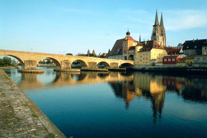 Regensburg's stone bridge and cathedral reflected in the Danube